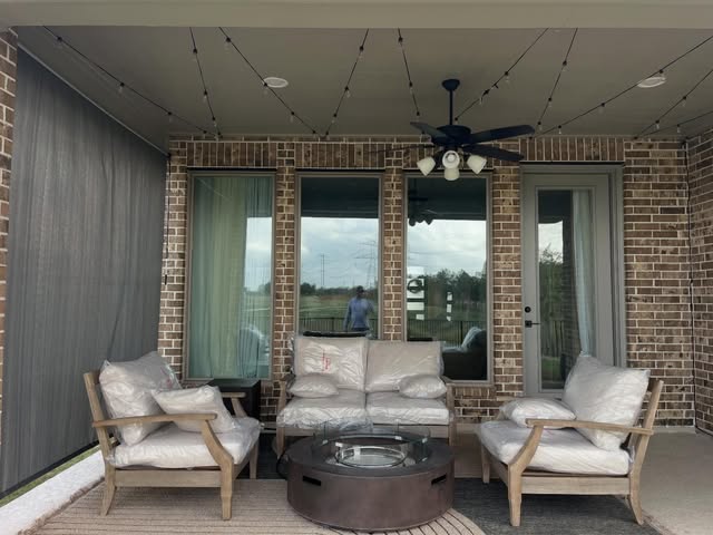 Covered porch with seating and a ceiling fan