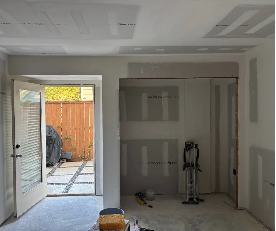 Room with new drywall and joint compound on walls and ceiling
